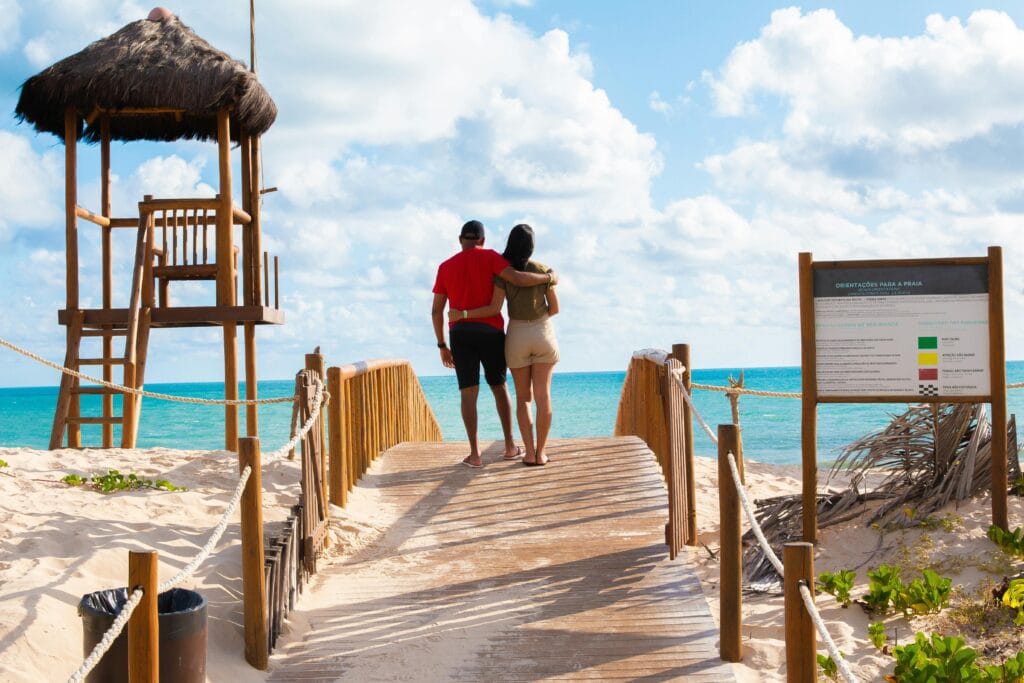 Young couple enjoying a luxury beach resort, representing affordable dream vacations