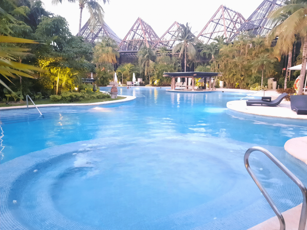 Luxury beachfront resort with infinity pool at sunset, representing RCI vacation opportunities.
