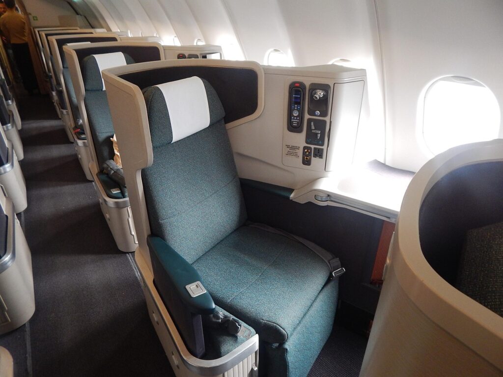 business-coach-1317868_1280 Luxury business class airplane seat with window view — symbolizing premium travel perks