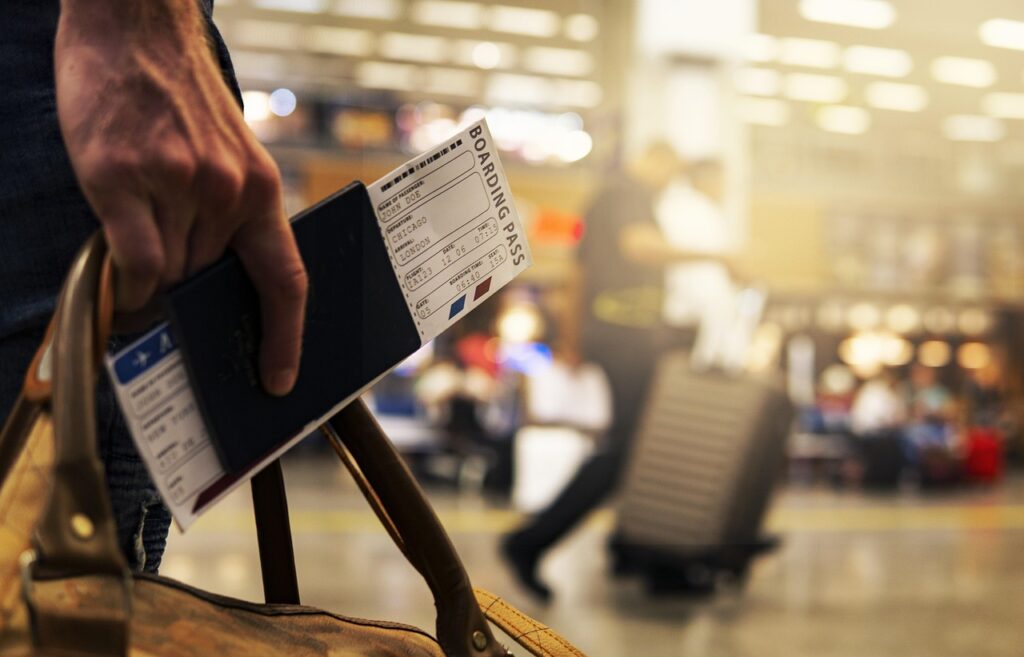Passport, boarding pass, and airline loyalty card on a travel desk — symbolizing frequent flyer programs and global travel.