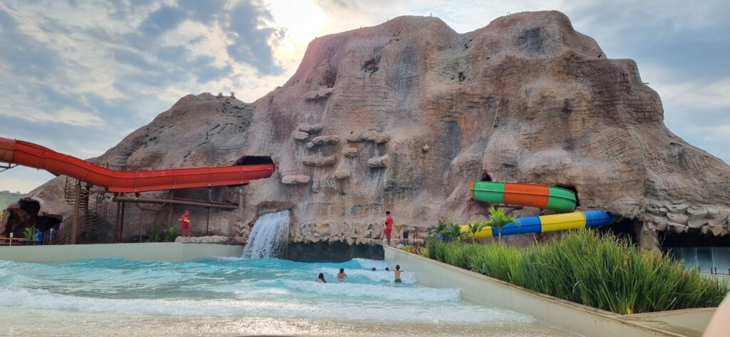 Caribbean resort water park with colorful slides, wave pool, and waterfall—family-friendly amenities near the beach