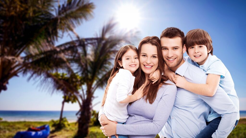Happy family at tropical beach — Brazil trip with e-Visa ready Smiling family with two kids at a tropical beach with palm trees and blue sky, ready for a Brazil vacation.