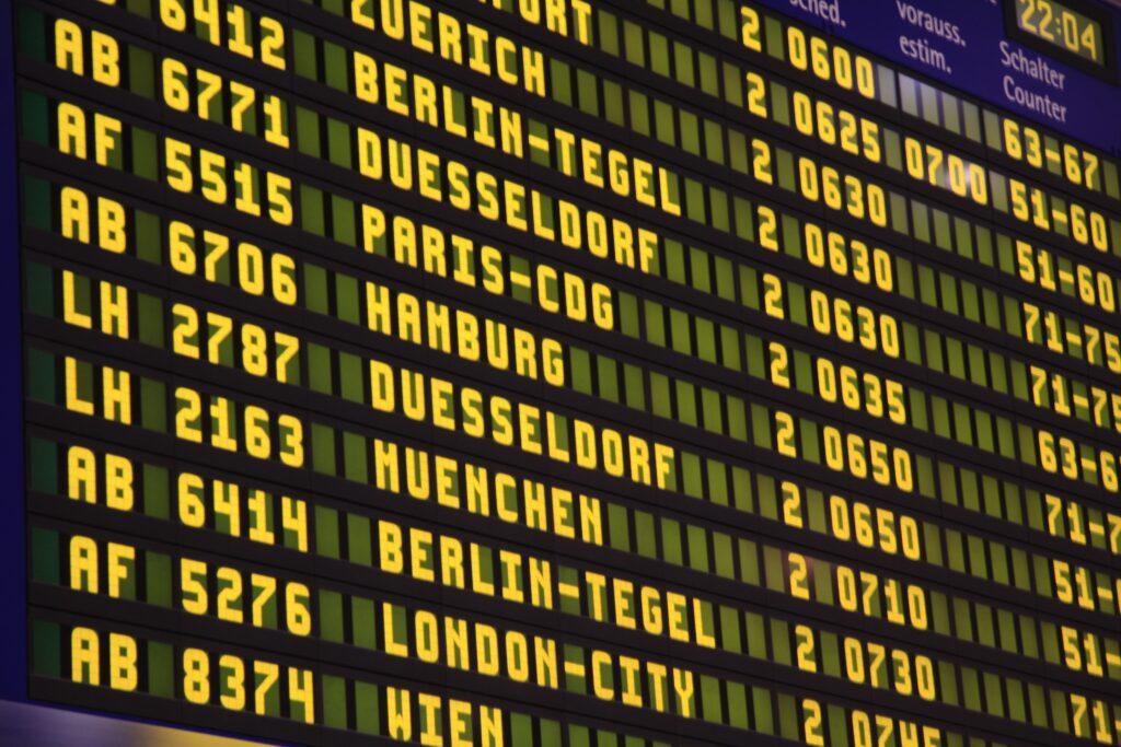 irport departure board showing multiple flight numbers for a single code-share flight, highlighting the marketing vs operating carrier dynamic.